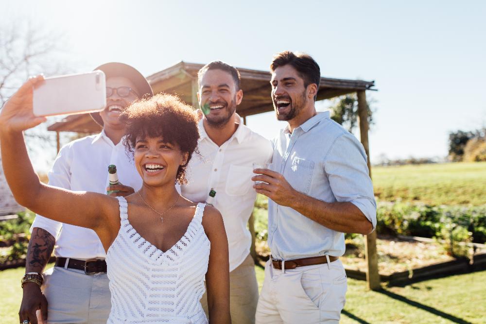 A group of friends taking a selfie in a vineyard