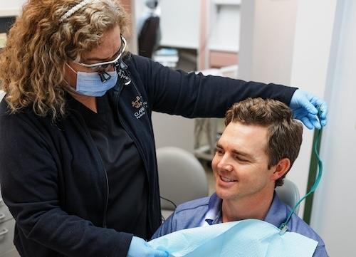 A registered dental hygienist working with a patient in Arlington