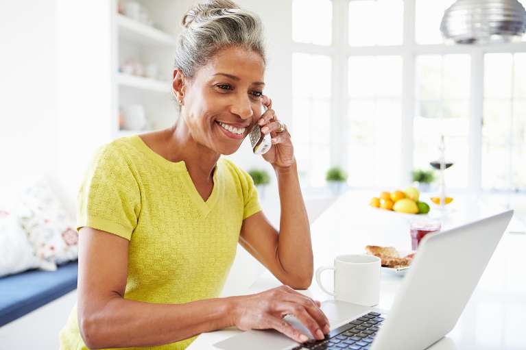 A woman talking on the phone while working from home