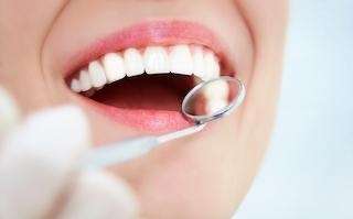 A smiling woman getting a dental exam