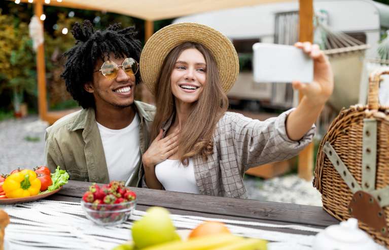 A smiling couple taking a selfie at lunch