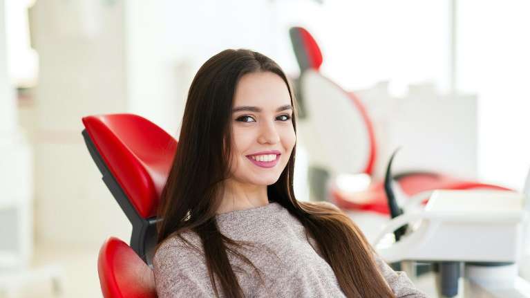 A smiling woman getting a dental exam