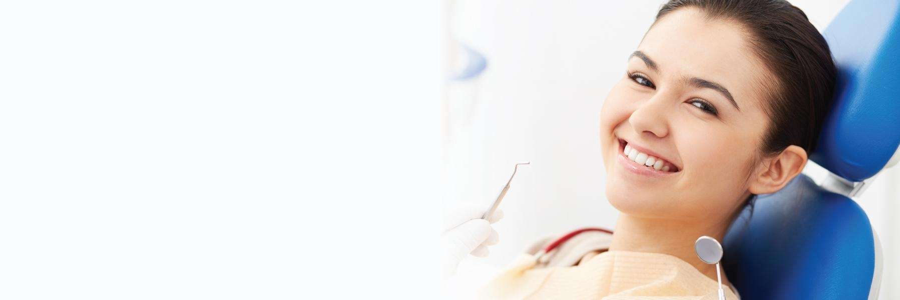 A smiling woman getting a dental exam