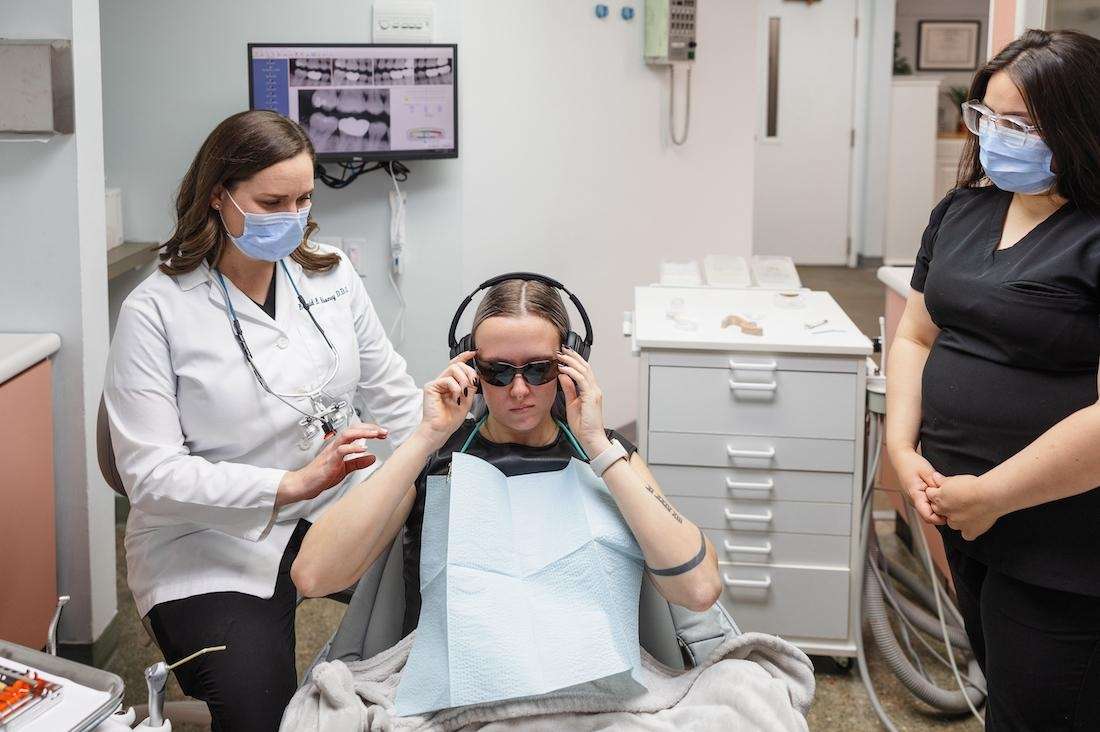 Dr Mooney working with a patient in the dental exam room