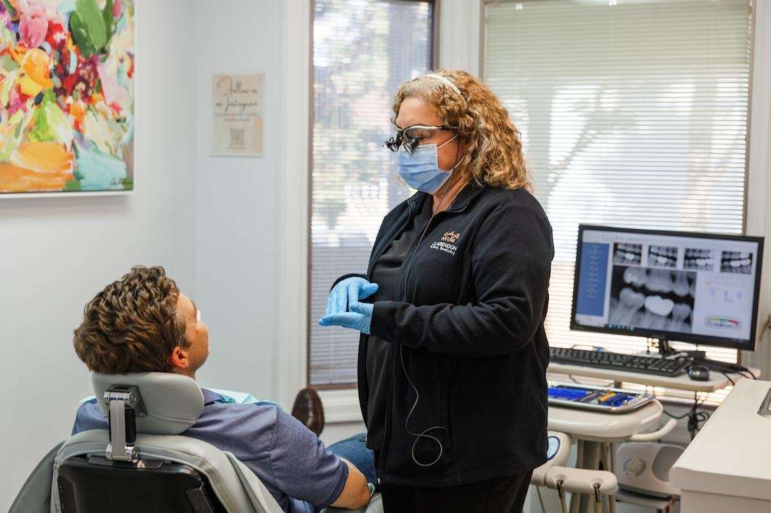 Dental staff working with a patient in the exam room