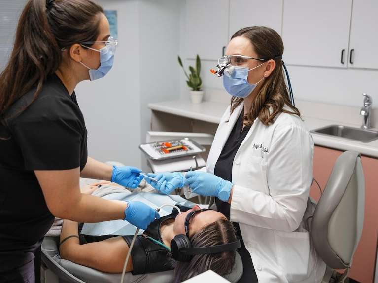 A patient at Clarendon Family Dentistry using noise canceling headphones