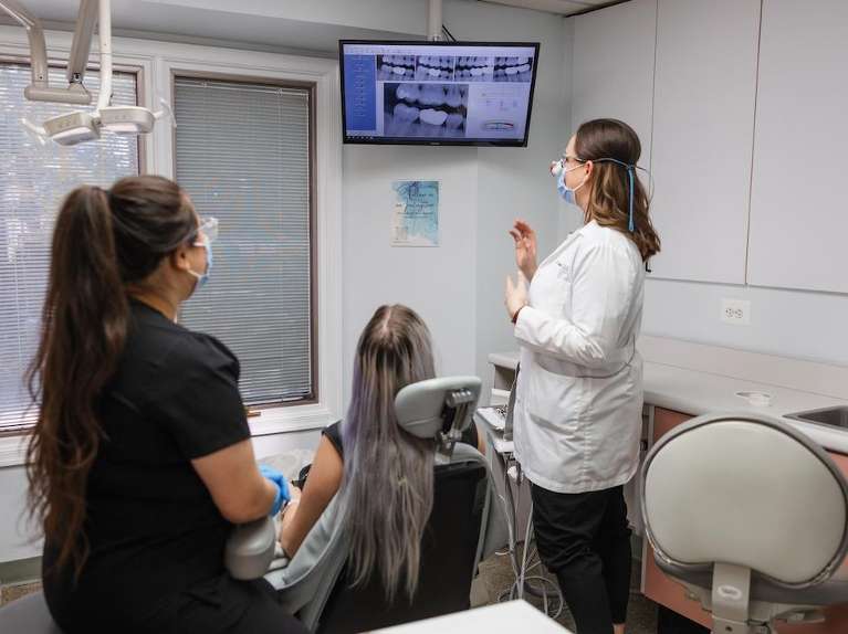 Dr. Mooney showing a patient her panoramic x-rays